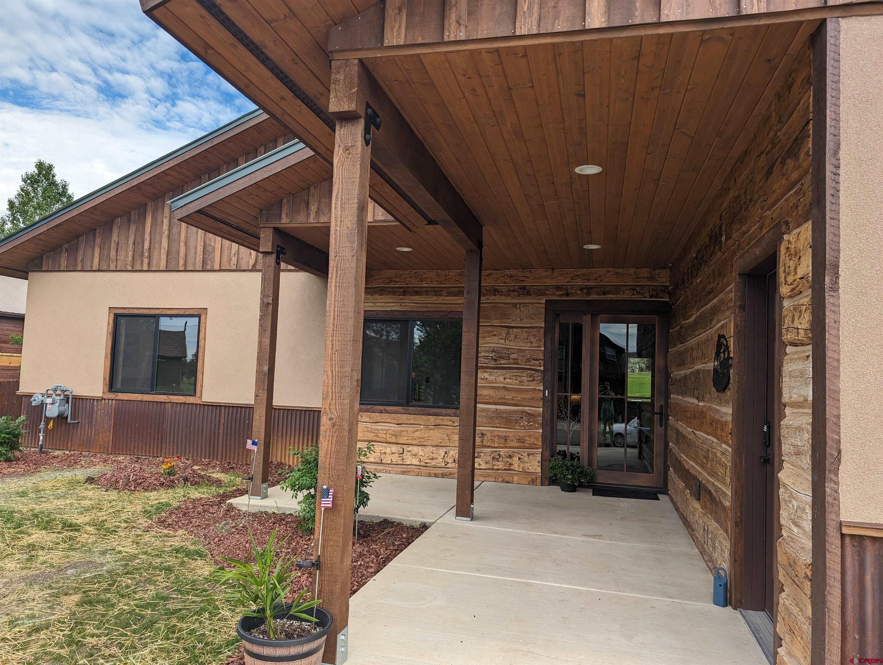 Image 3: covered entry with reclaimed wood siding