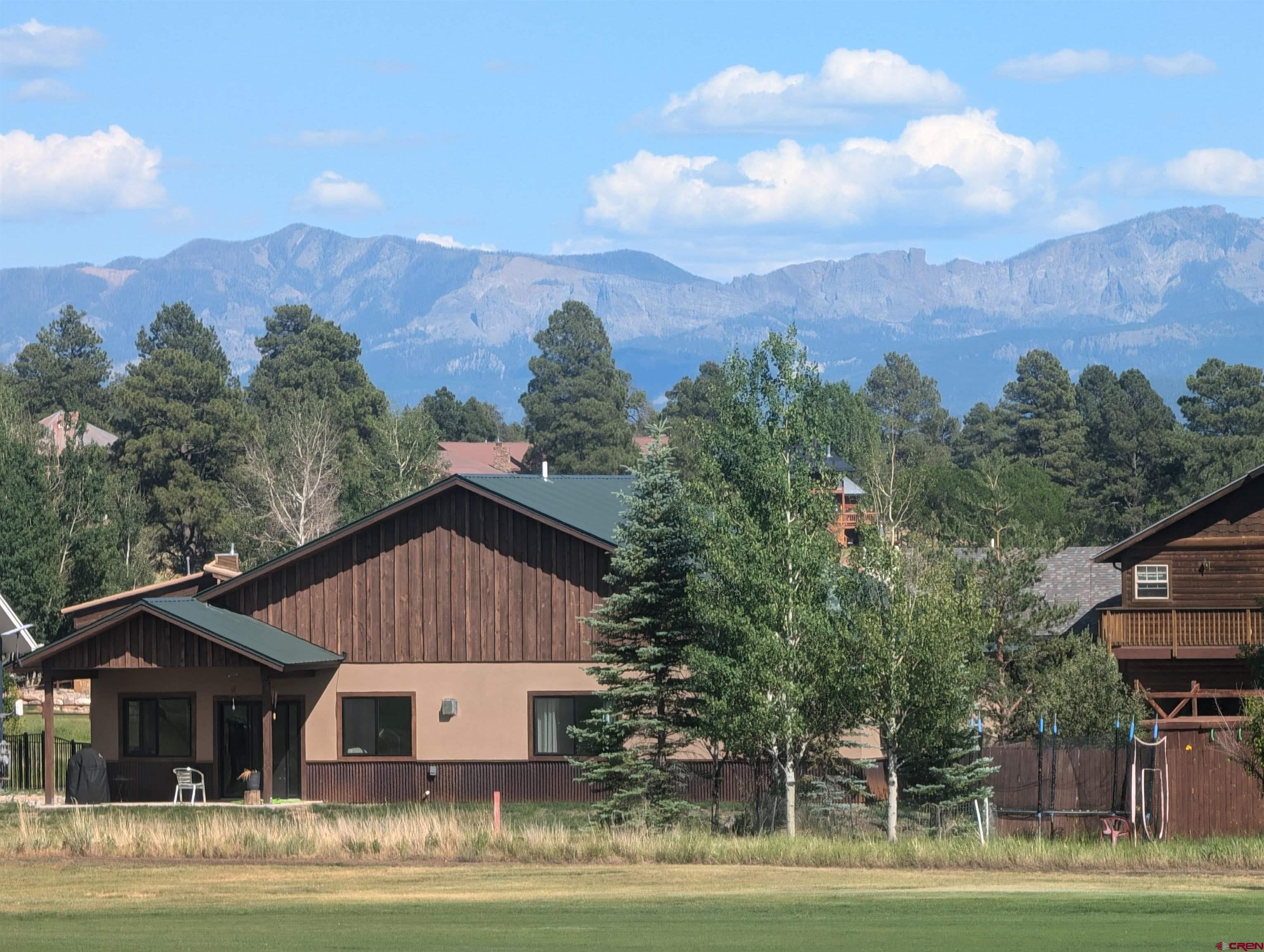 Image 1: golf course side of the home