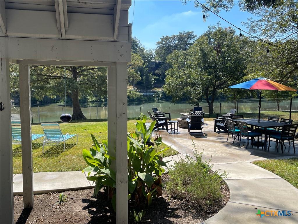 Image 2: View of Lake McQueeney, firepit/patio area, and pe