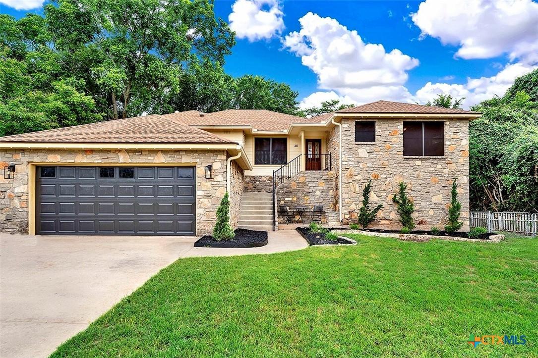 Image 1: Front Exterior with freshly painted garage door an