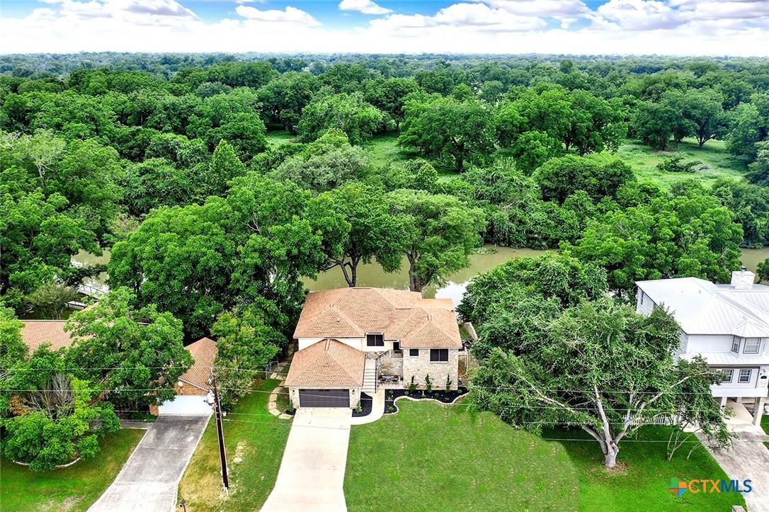 Image 3: Riverfront retreat nestled beneath mature trees