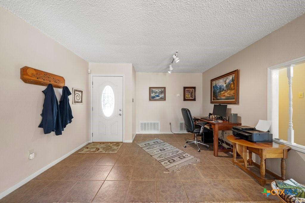 Image 2: Entry foyer w/ dining area currently used as offic
