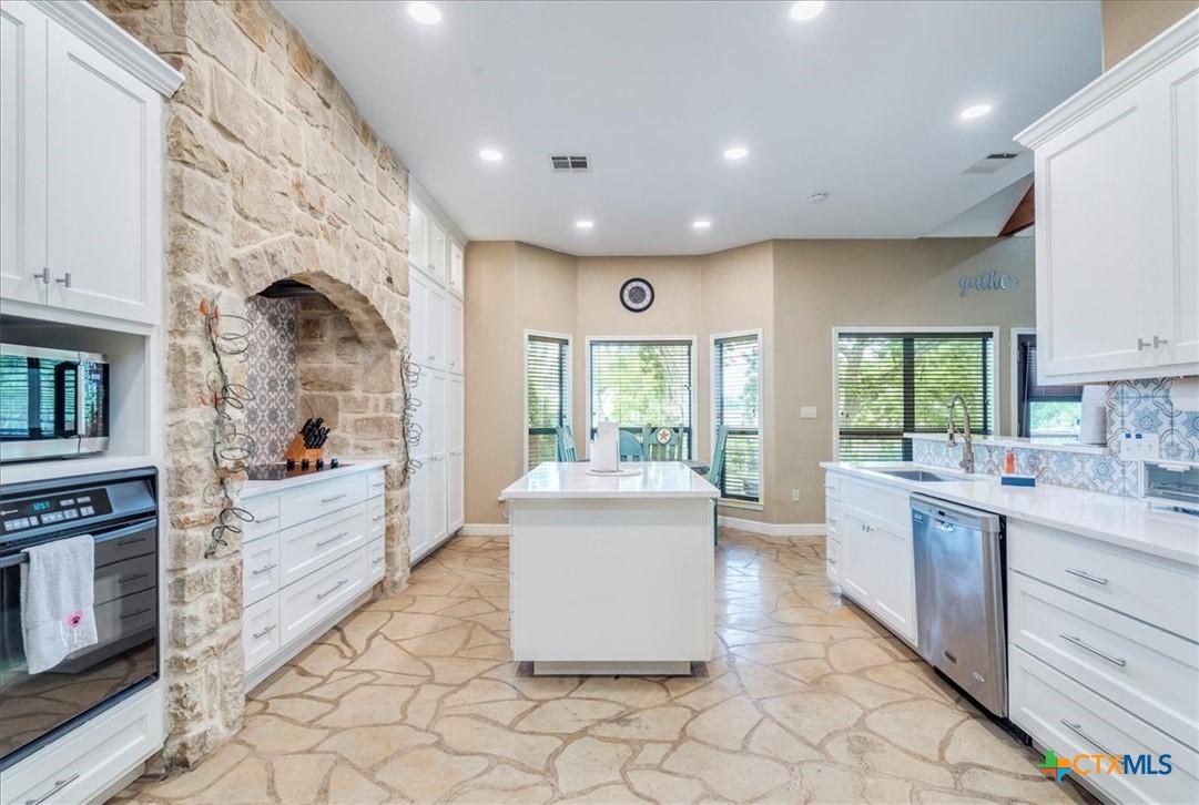 Image 4: Kitchen was remodeled in 2021, and features quartz
