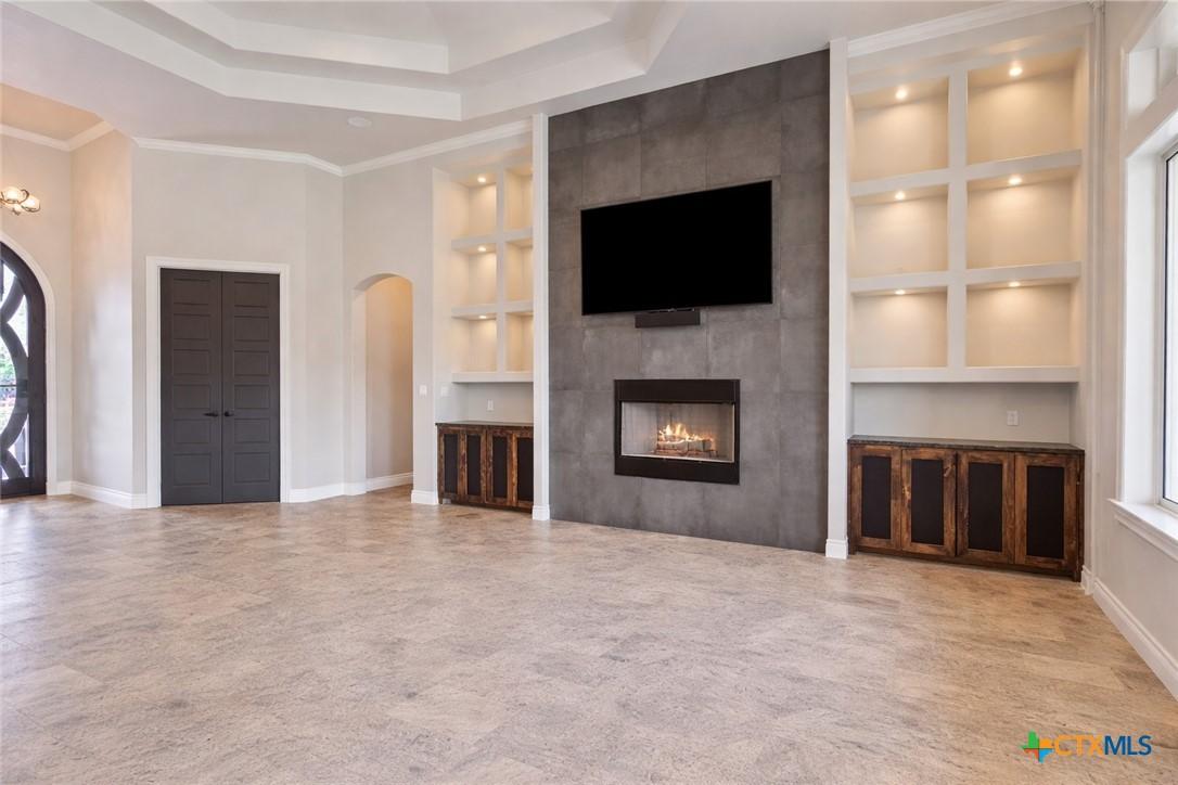 Image 4: Custom built-ins and lit shelving