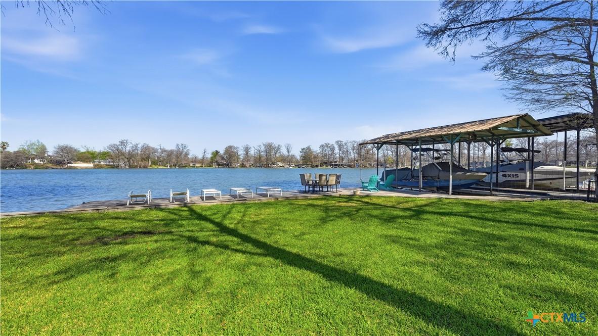 Image 1: LAWN LEADING TO WATERFRONT DECK, DINING AREA AND B