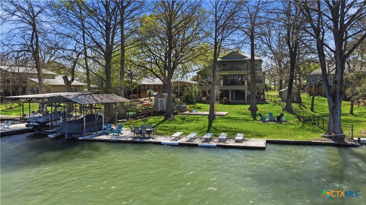 Image 2: VIEW OF IMPROVED WATERFRONT, LAWN, FIREPIT, AND BA