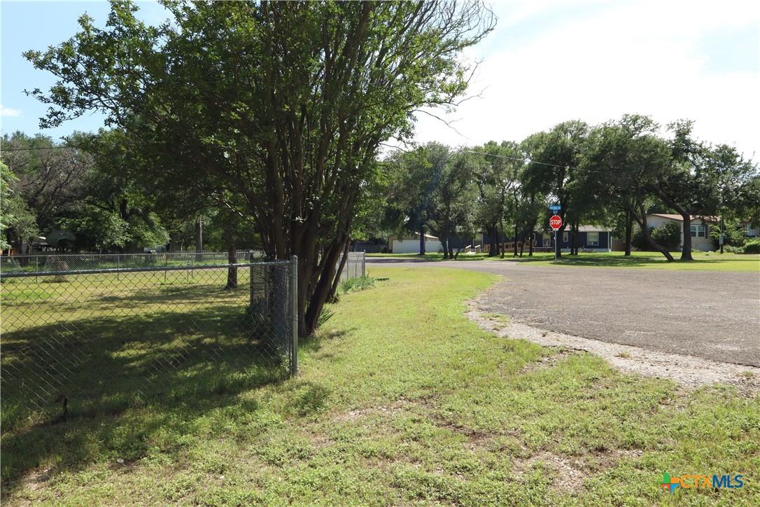 Image 4: Cleared Lot Framed by Mature Landscaping on a Cul-