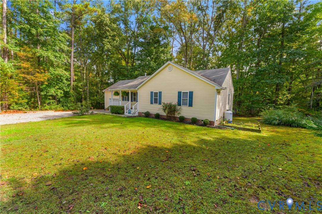 Image 3: Single story home featuring a front yard, covered
