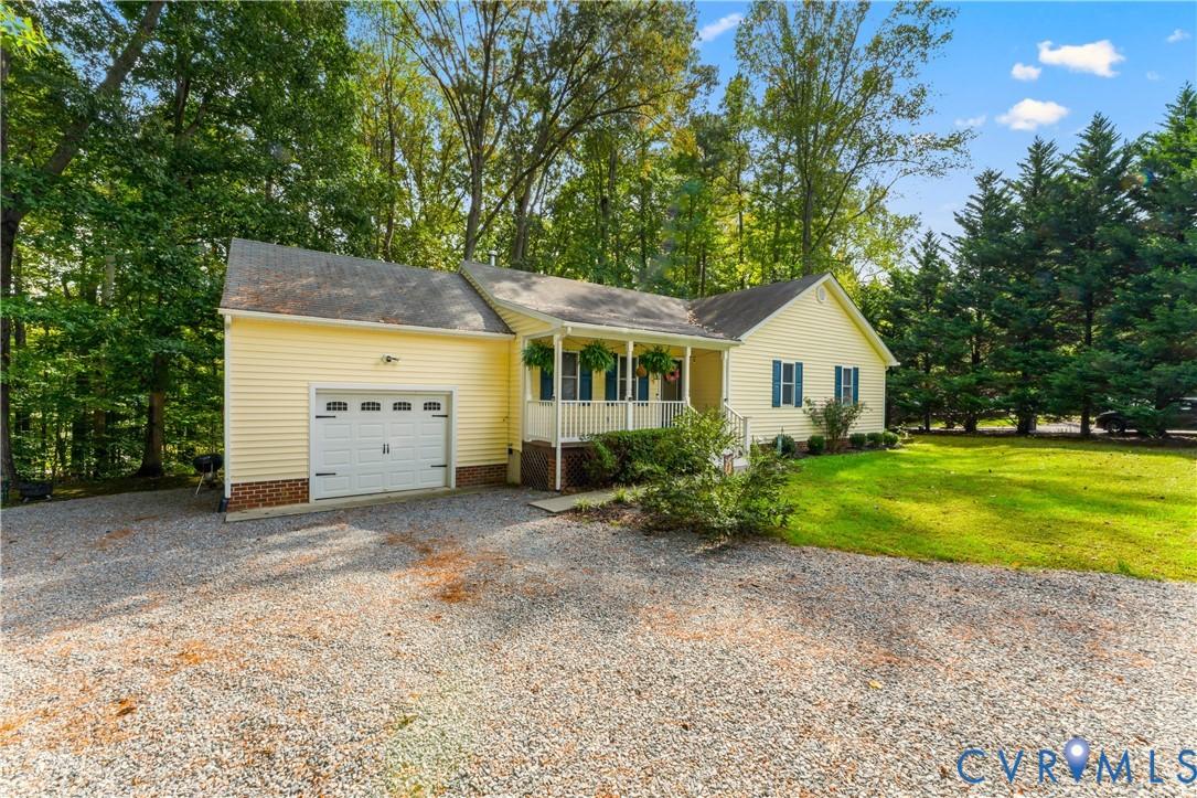 Image 4: View of front of home with covered porch, driveway