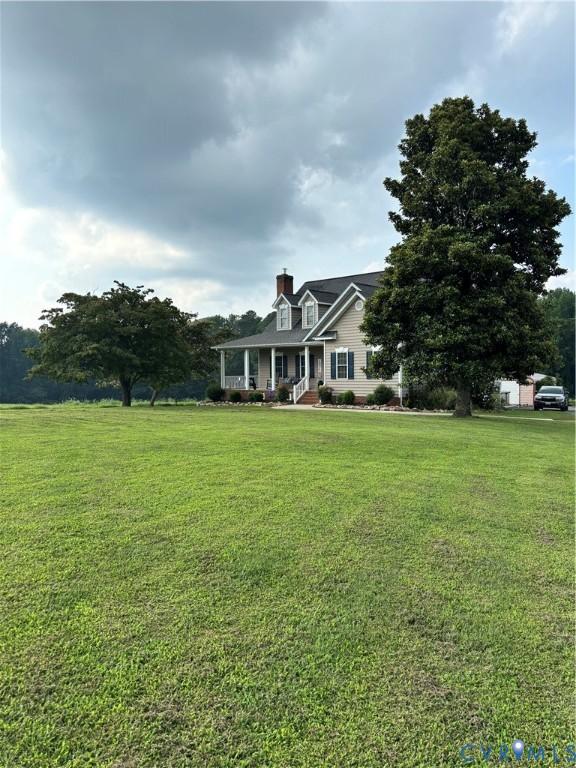 Image 1: Expansive green lawn with a Cape Cod home featurin