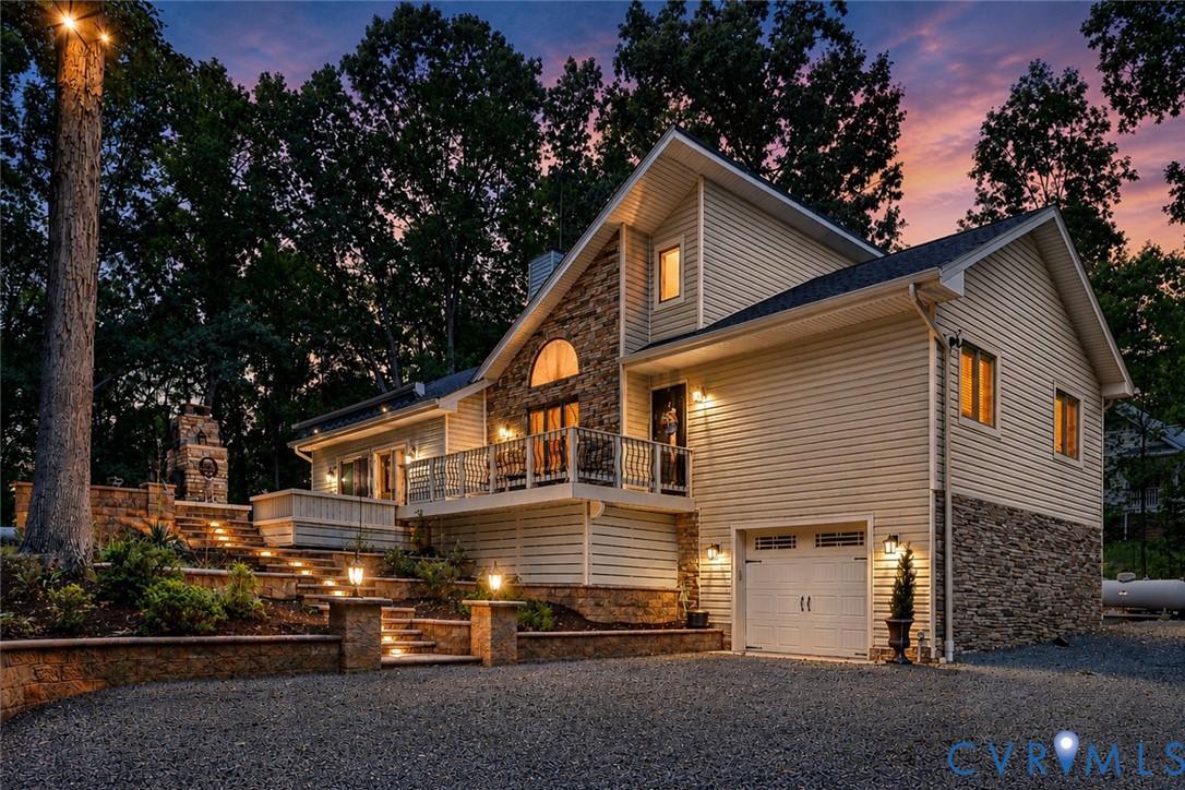 Image 1: Multi-level exterior featuring stone accents and l