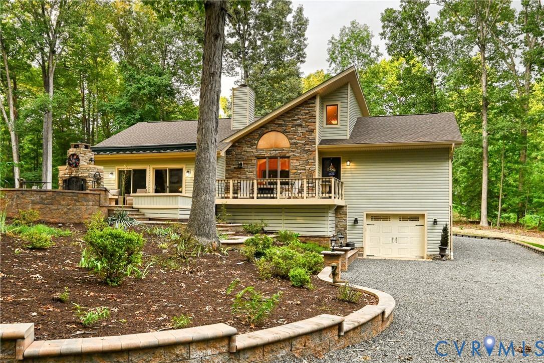 Image 4: Multi-level home featuring stone and siding exteri