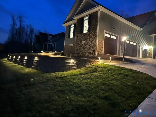 Image 4: Garage side of the property exterior at twilight f