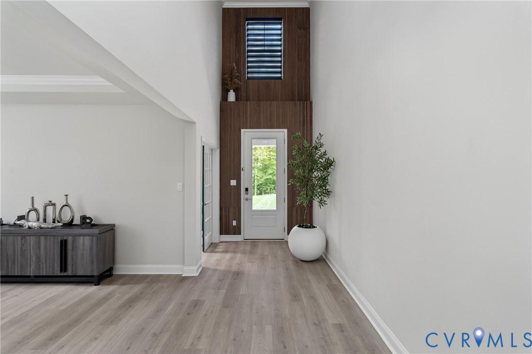 Image 2: Foyer entrance with light wood finished floors and
