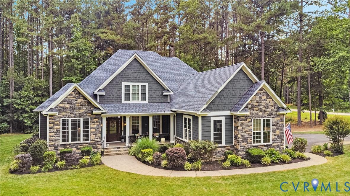 Image 1: Stone and siding exterior with a multi-gabled roof
