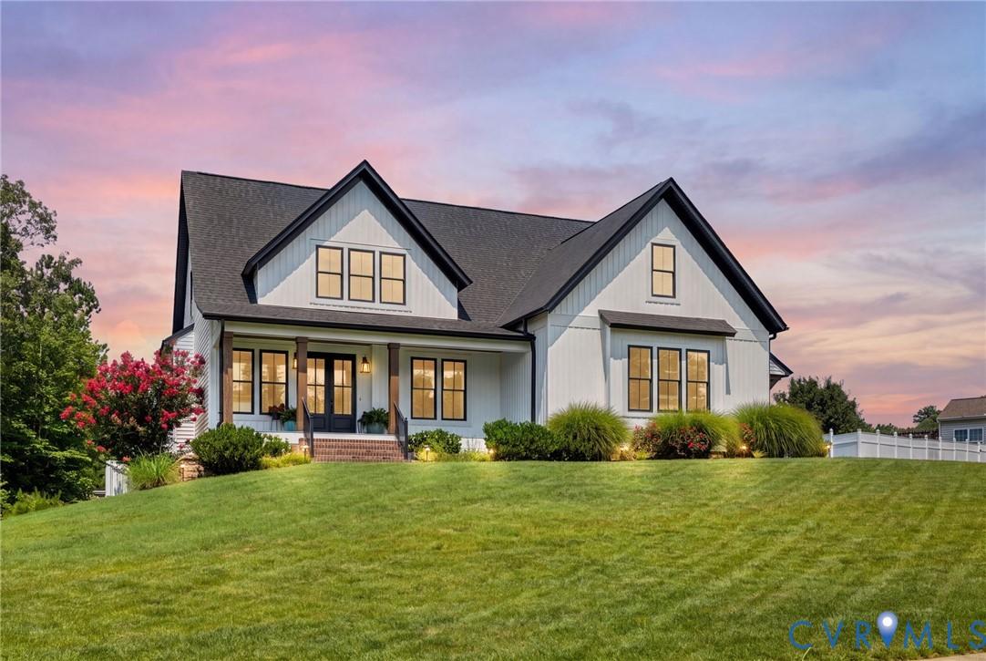 Image 2: Modern farmhouse exterior featuring white siding,