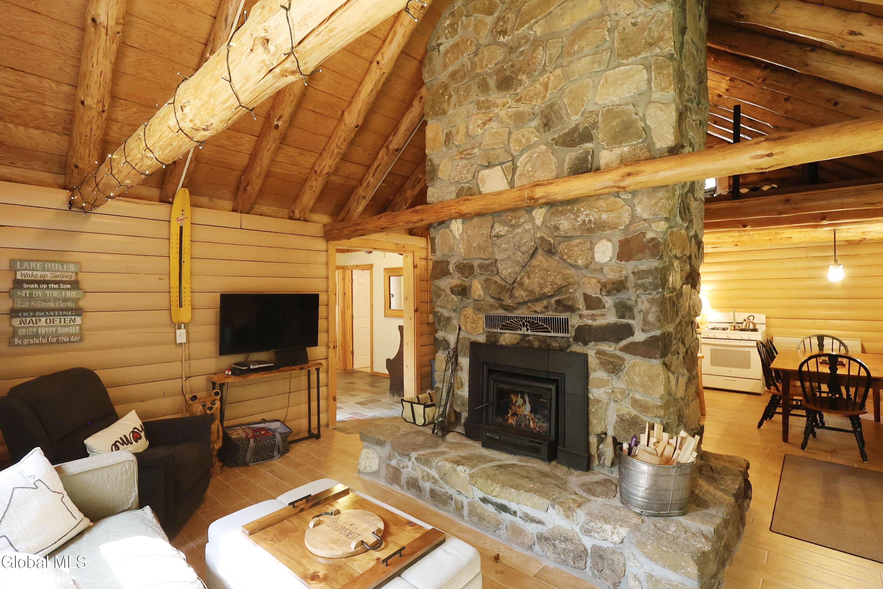 Image 3: Floor to ceiling wood burning fireplace