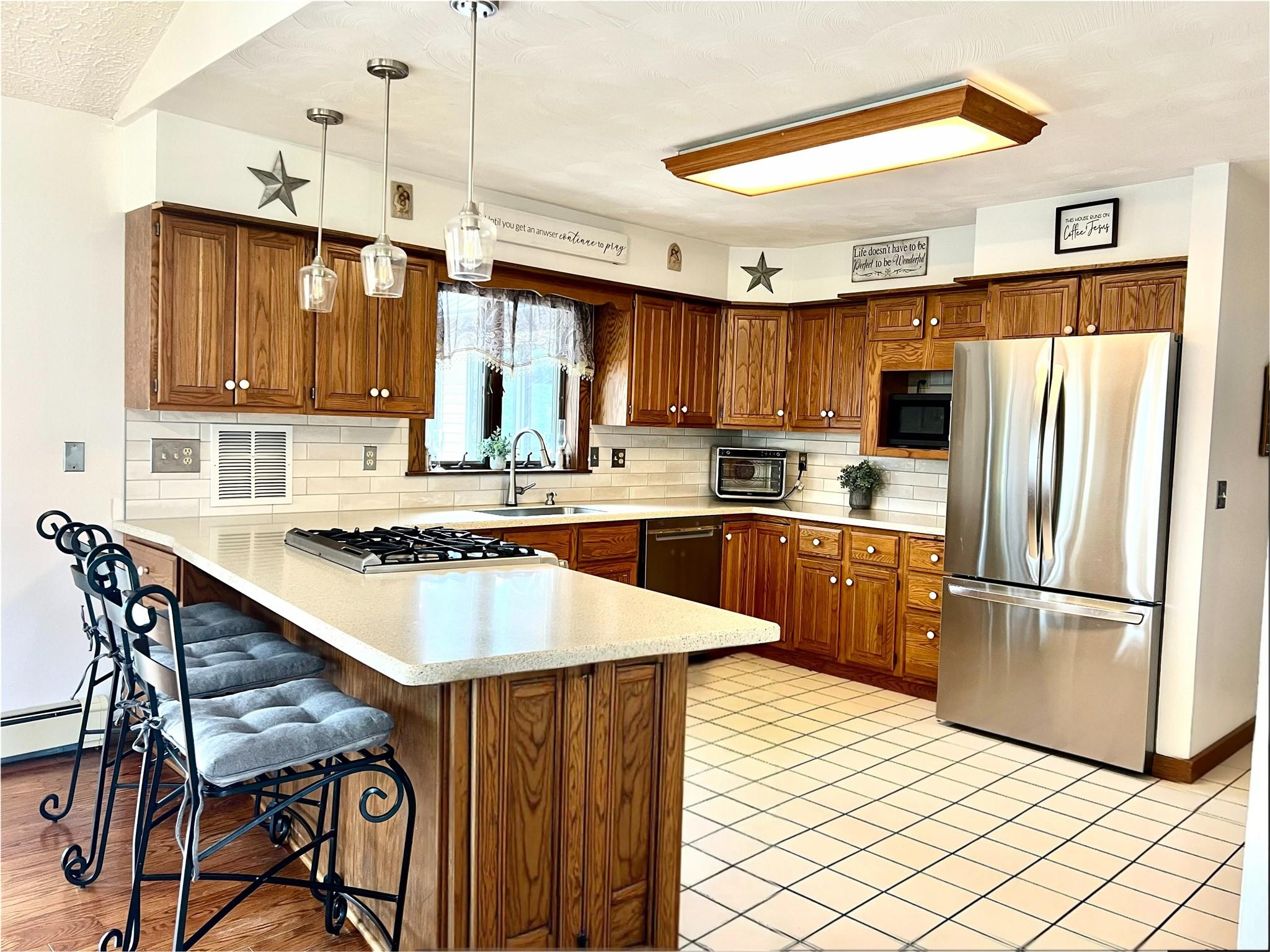 Image 4: Updated kitchen features glass-tlled back splash,