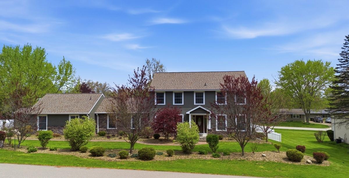 Image 1: Front - This exceptional home offers curb appeal p