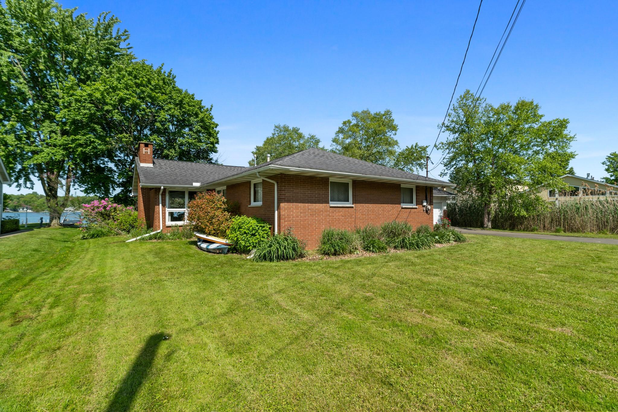 Image 1: Rear view of home and Conneaut Lake