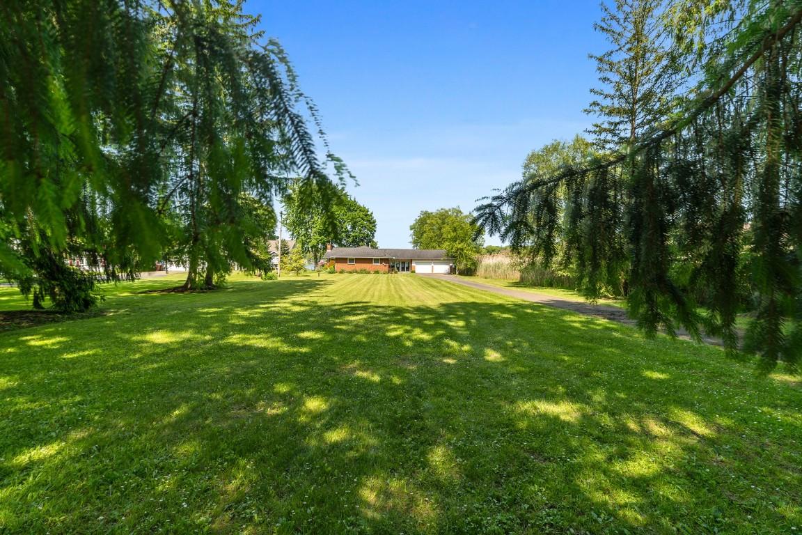 Image 3: .88 Acre, sits back from the road