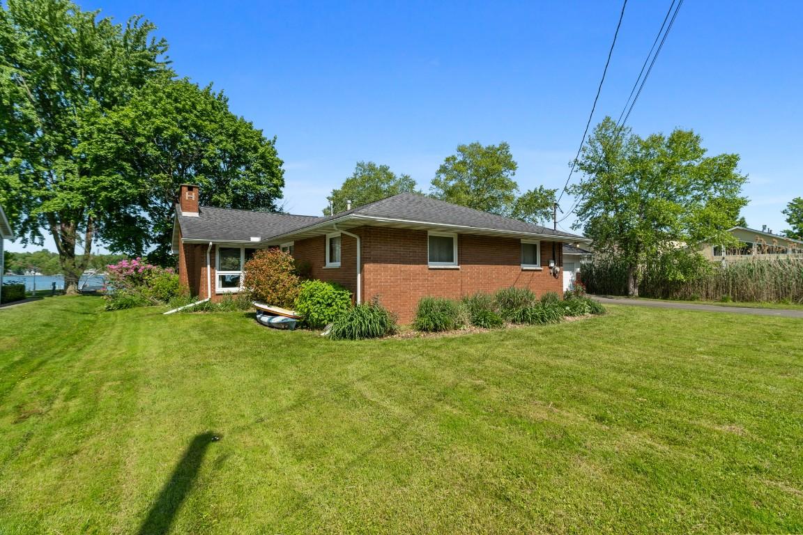 Image 4: Rear view of home and Conneaut Lake