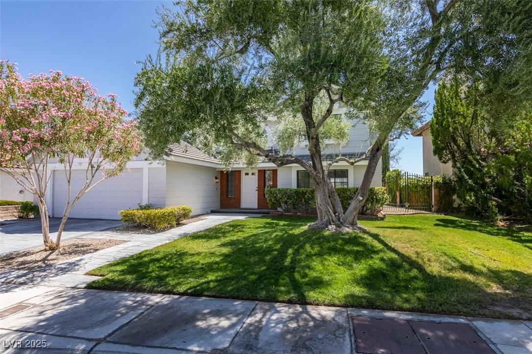 Image 2: Obstructed view of property featuring a front lawn