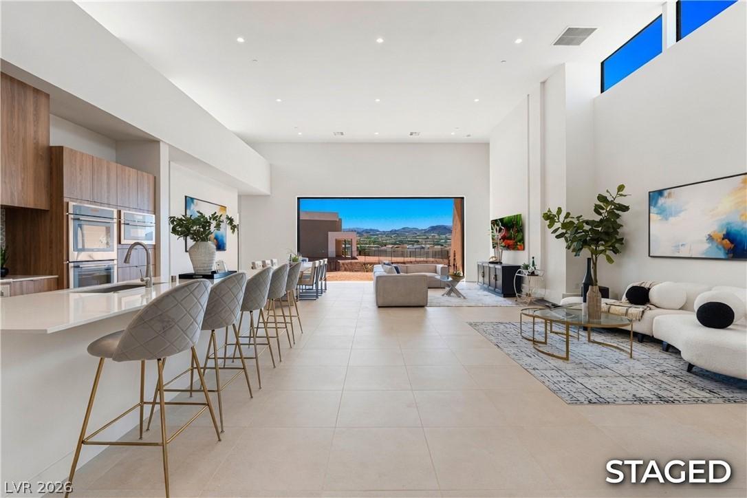 Image 2: An open-concept living space with elevated ceiling