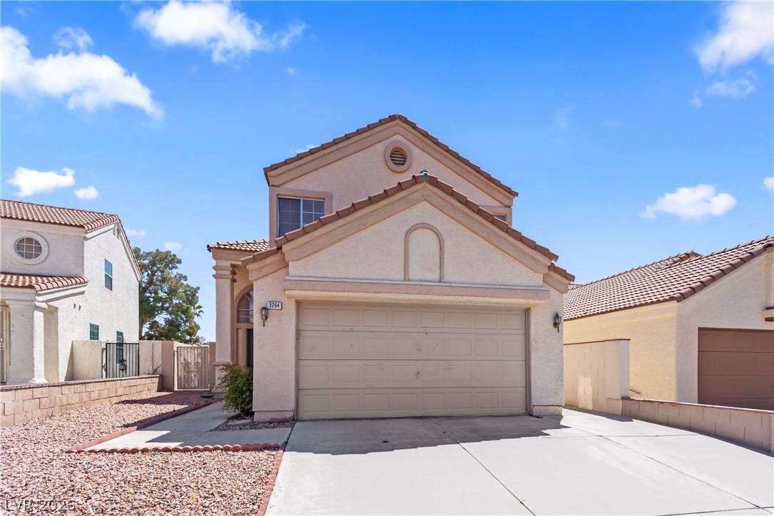 Image 3: This two-story home features an attached garage an