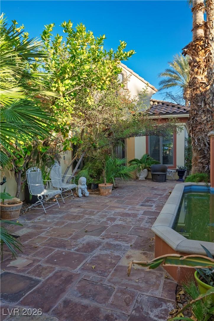 Image 3: View of patio featuring an outdoor pool