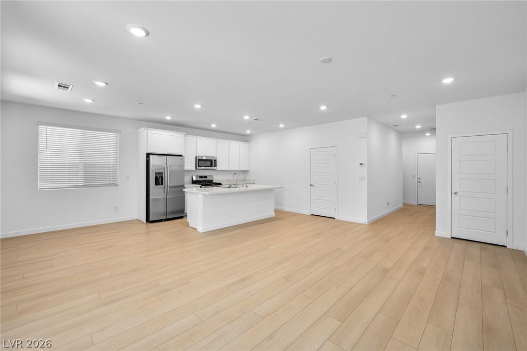 Image 4: An open-concept living space with a pristine kitch