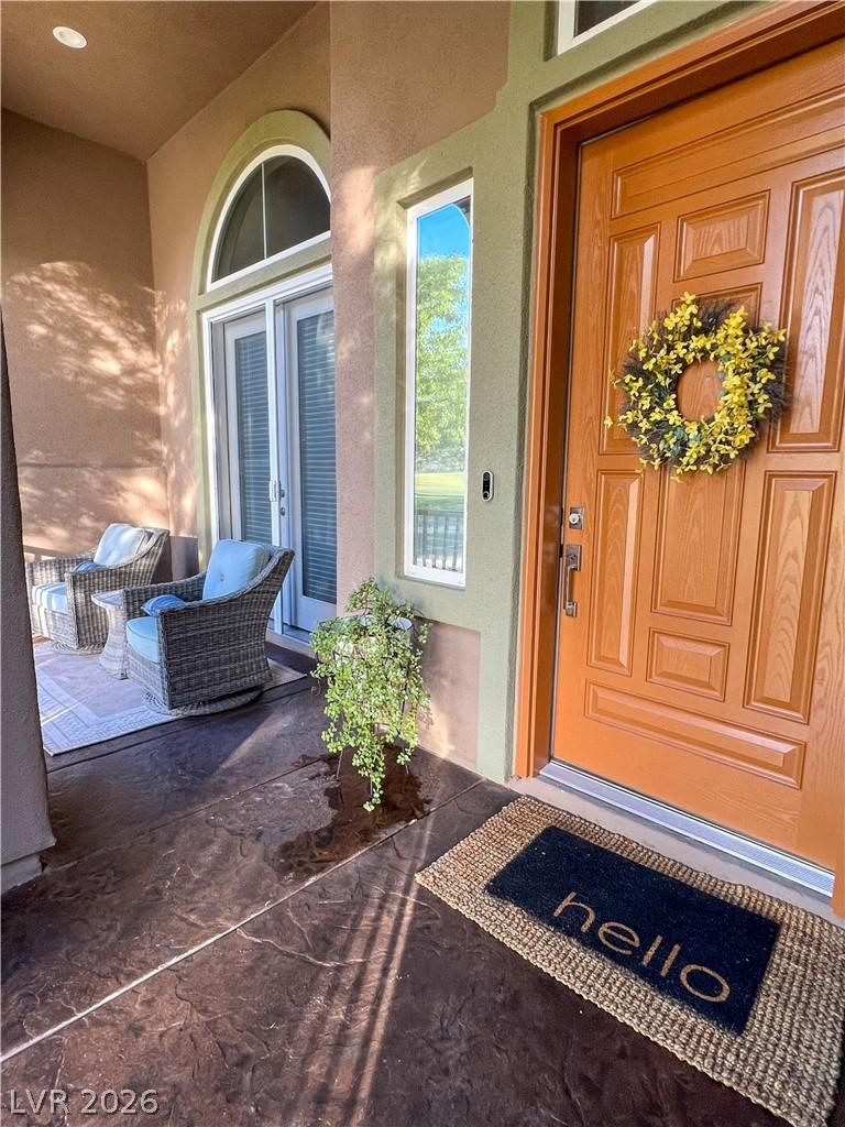 Image 3: A welcoming front porch features a wood entry door