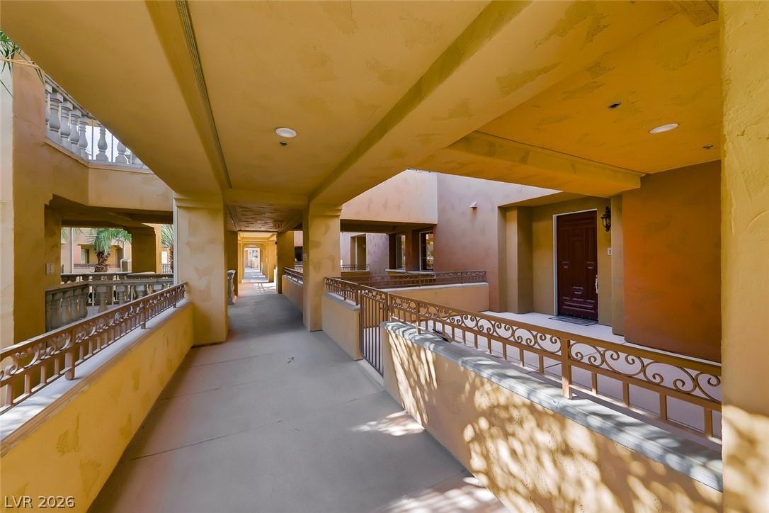 Image 2: A long, covered outdoor walkway leads to private e