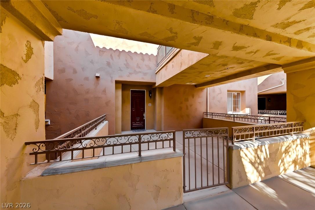 Image 3: A well-lit exterior walkway leads to a private ent