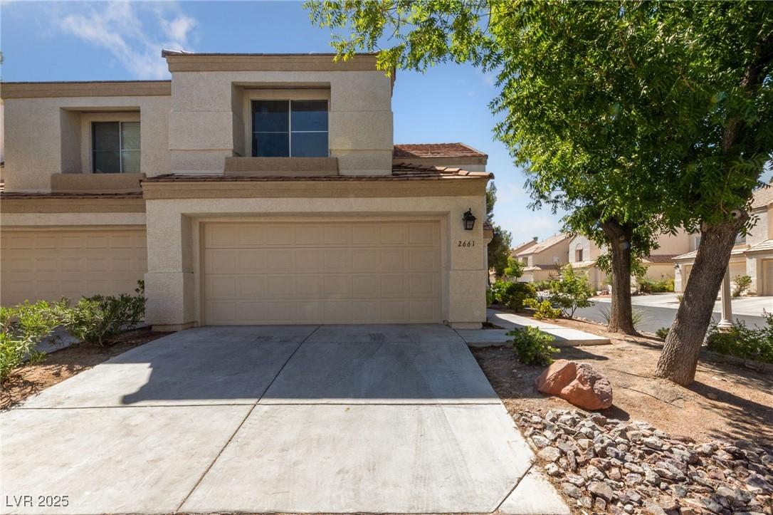 Image 1: View of front of property featuring concrete drive