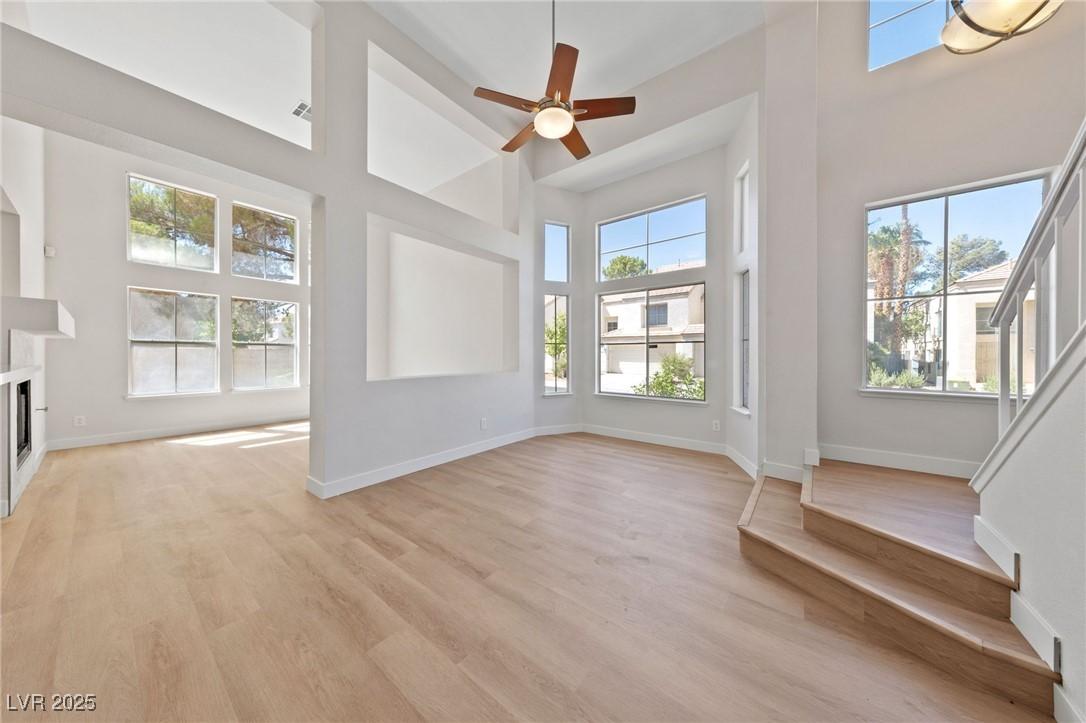 Image 3: Unfurnished living room with a towering ceiling, s