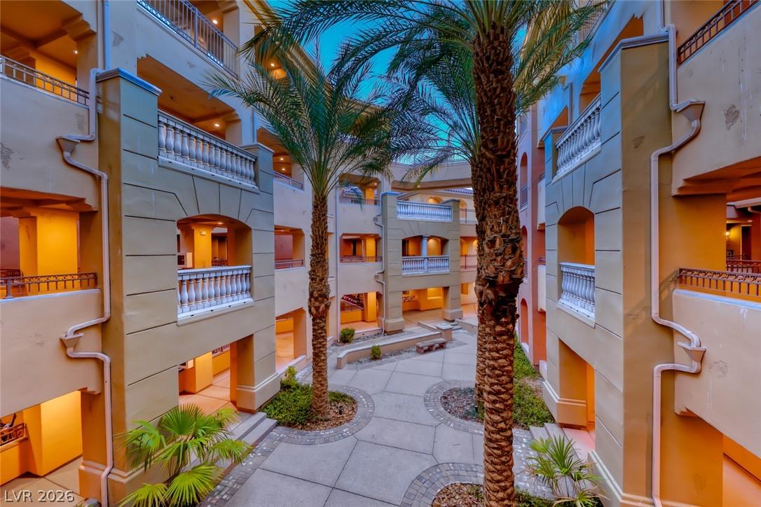 Image 2: A well-maintained courtyard garden, flanked by pal