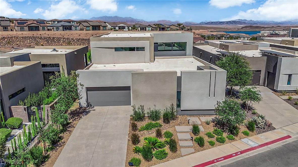 Image 1: Modern home with stucco siding, a residential view