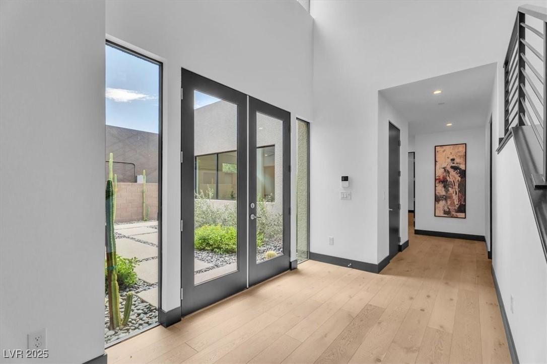 Image 4: Doorway to outside featuring hardwood / wood-style