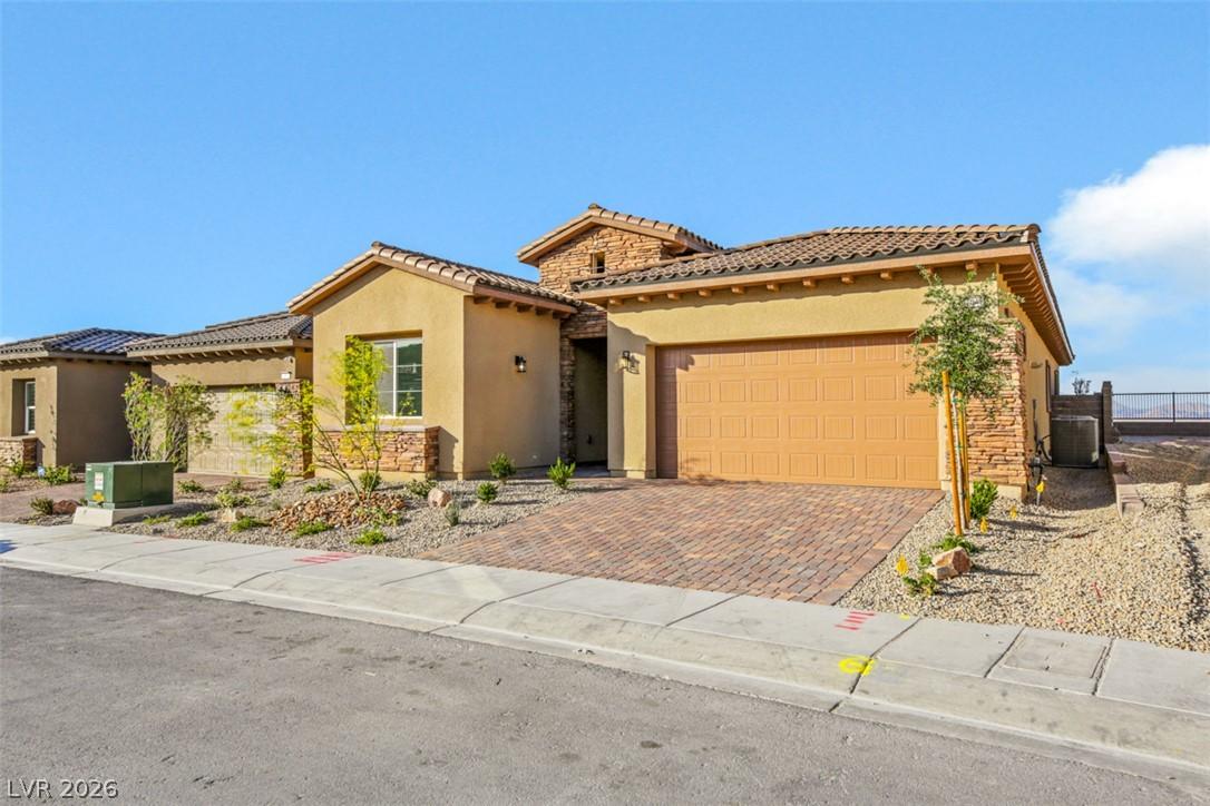 Image 1: A charming stucco home with a terracotta roof and
