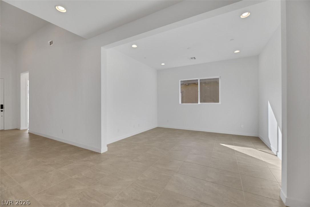 Image 3: Recessed lighting illuminates the open-concept liv
