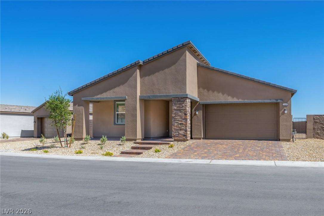 Image 2: This desert-style residence presents a welcoming f