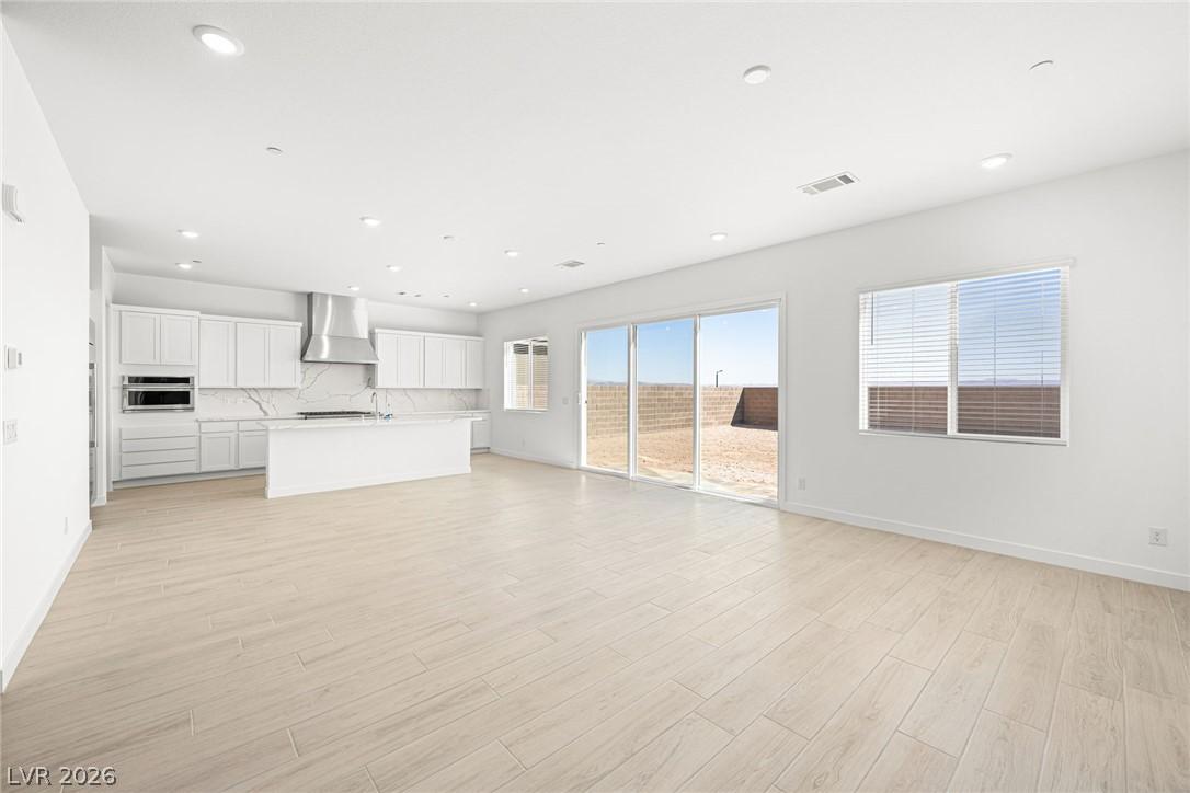 Image 3: A spacious, open-concept interior features bright