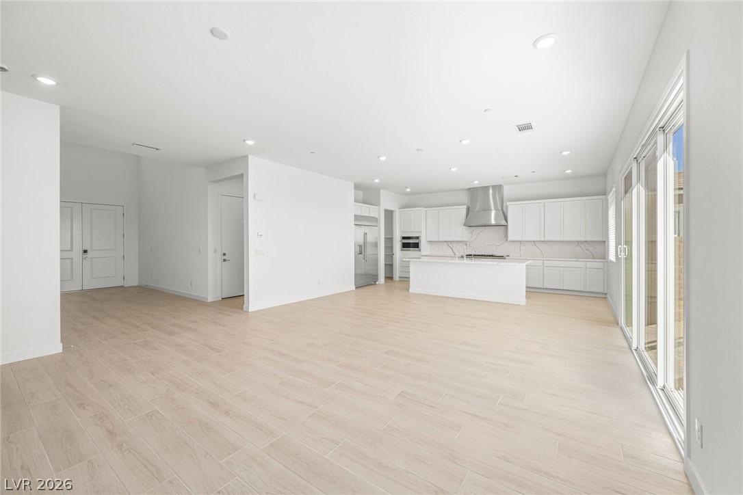 Image 4: An open-concept living space with a modern kitchen
