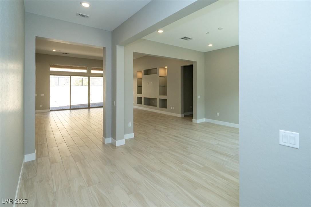 Image 3: Empty room with light wood-type flooring and reces