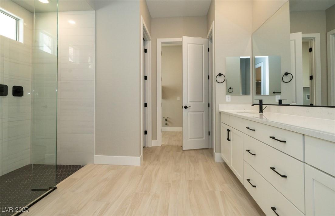 Image 4: Bathroom with vanity, walk in shower, and light wo
