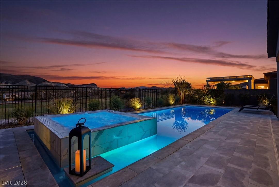 Image 1: An illuminated pool and spa invite evening relaxat