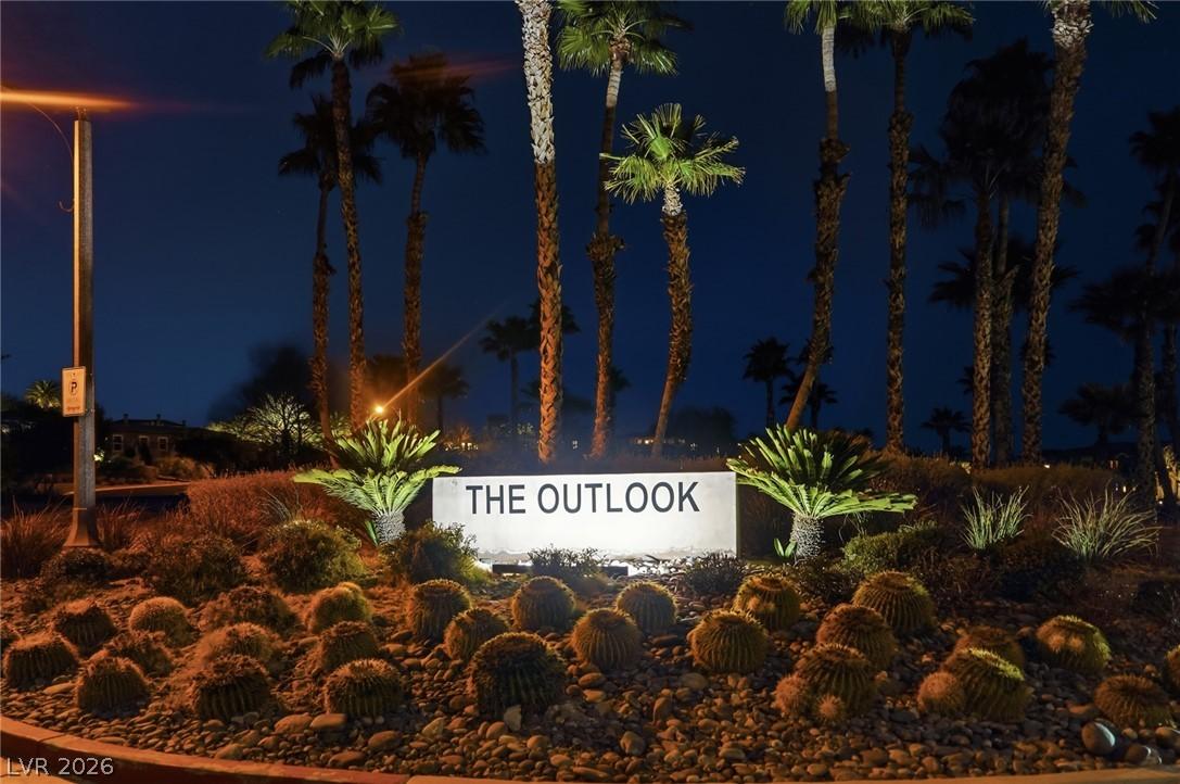 Image 2: Illuminated entry sign with lush desert landscapin