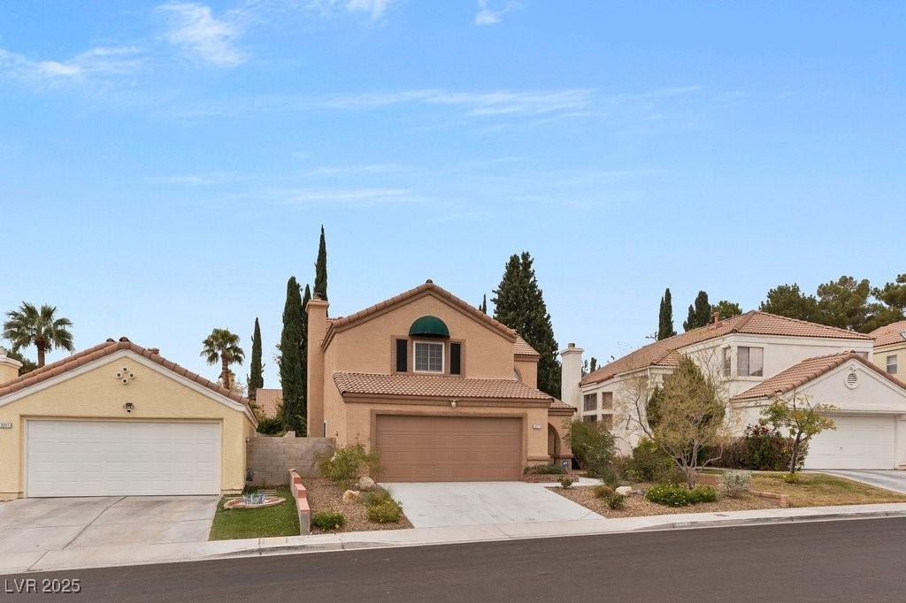 Image 4: View of front of home featuring a tile roof, stucc