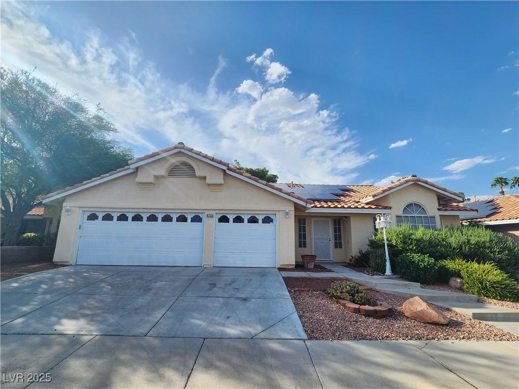 Image 1: Single story home with stucco siding, an attached